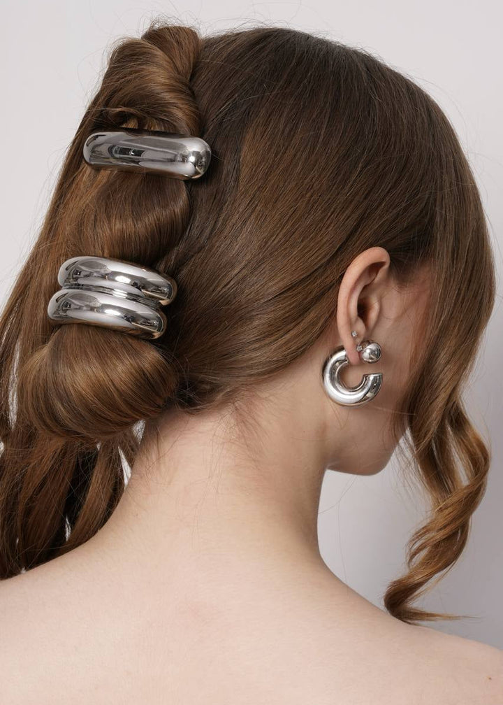 Model wearing Celeste silver hoop earrings with silver hair cuffs in a half up style, Luvertta